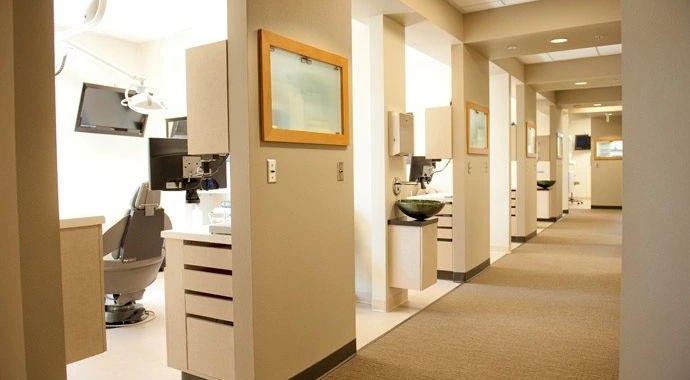 Completed dental practice corridor with operatory bays and casework